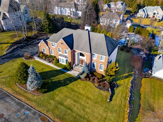 a view of a patio with a table and chairs and a barbeque