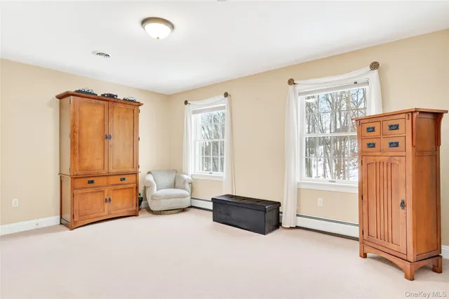 a bedroom with a bed a couch and a window