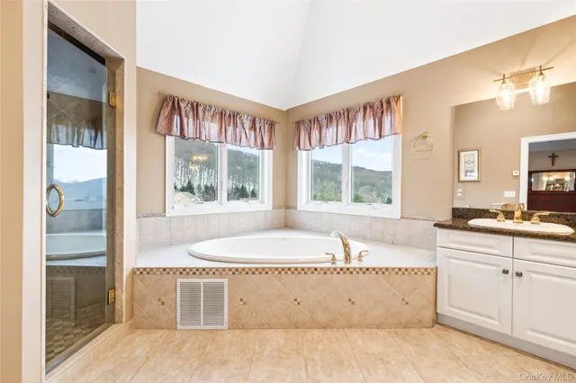 a bathroom with a granite countertop sink mirror toilet and shower