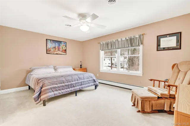 a room with pool table and windows