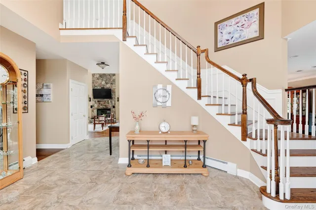 a living room with furniture and a flat screen tv with wooden floor