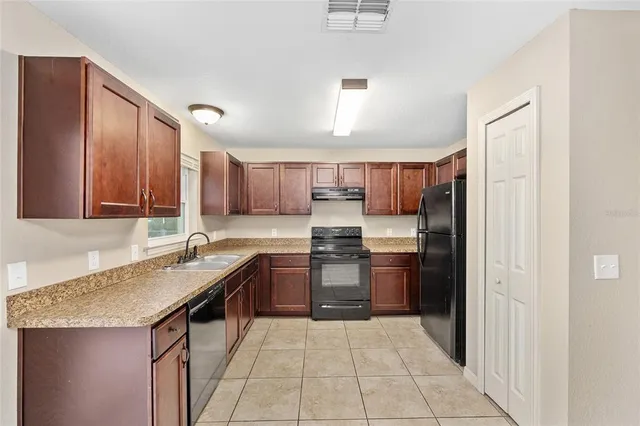 a kitchen with a sink stove and cabinets