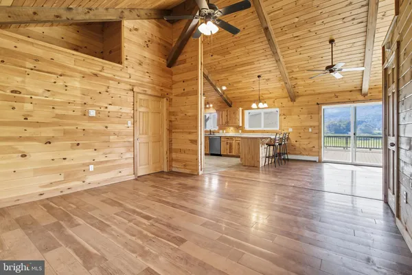 a kitchen with stainless steel appliances granite countertop a sink a stove a refrigerator cabinets and entryway