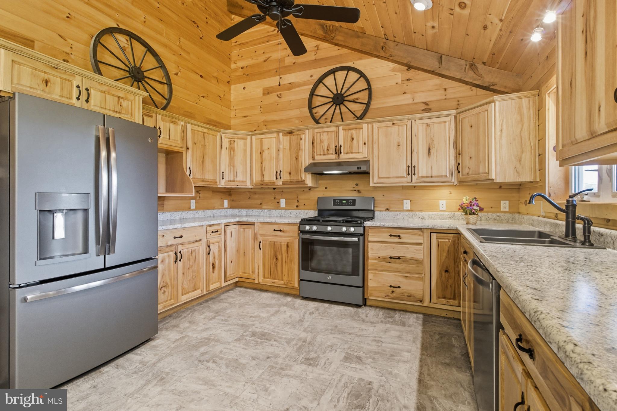107 Linkin Park Drive Spring Mills, PA 16875 - Photo 24 of 66 a kitchen with stainless steel appliances granite countertop a sink a stove a refrigerator cabinets and entryway