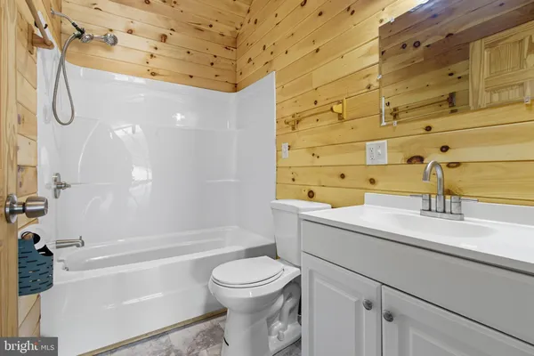 a kitchen with stainless steel appliances granite countertop a stove top oven a refrigerator a sink and white cabinets