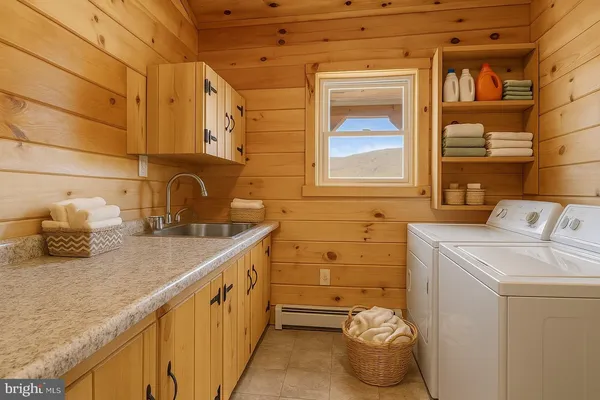 a kitchen with kitchen island granite countertop a refrigerator a stove a sink a dining table and chairs with wooden floor