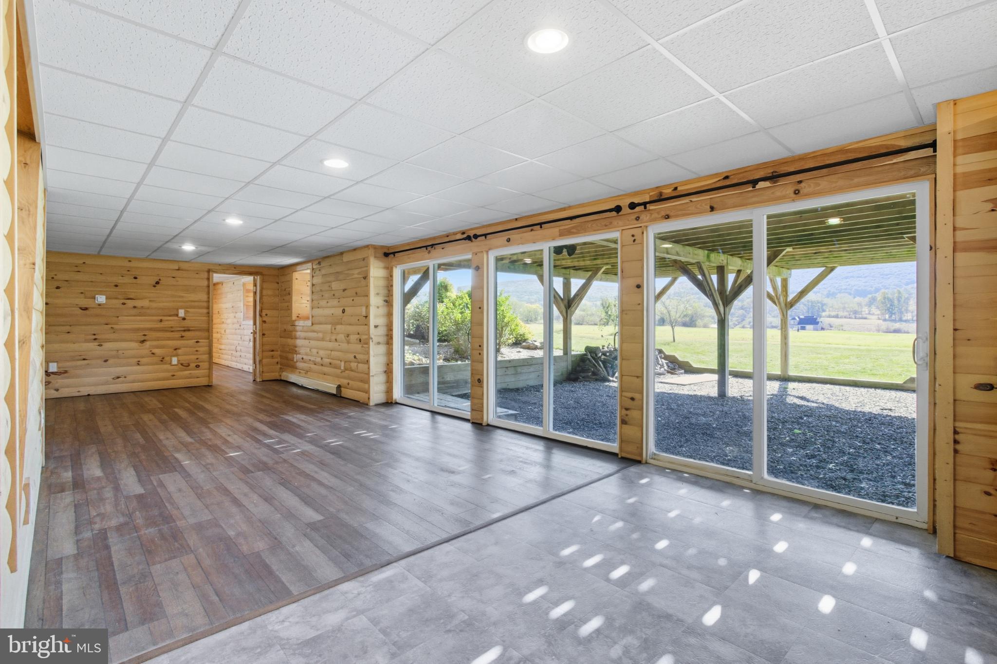 107 Linkin Park Drive Spring Mills, PA 16875 - Photo 47 of 66 a view of an empty room with wooden floor and windows