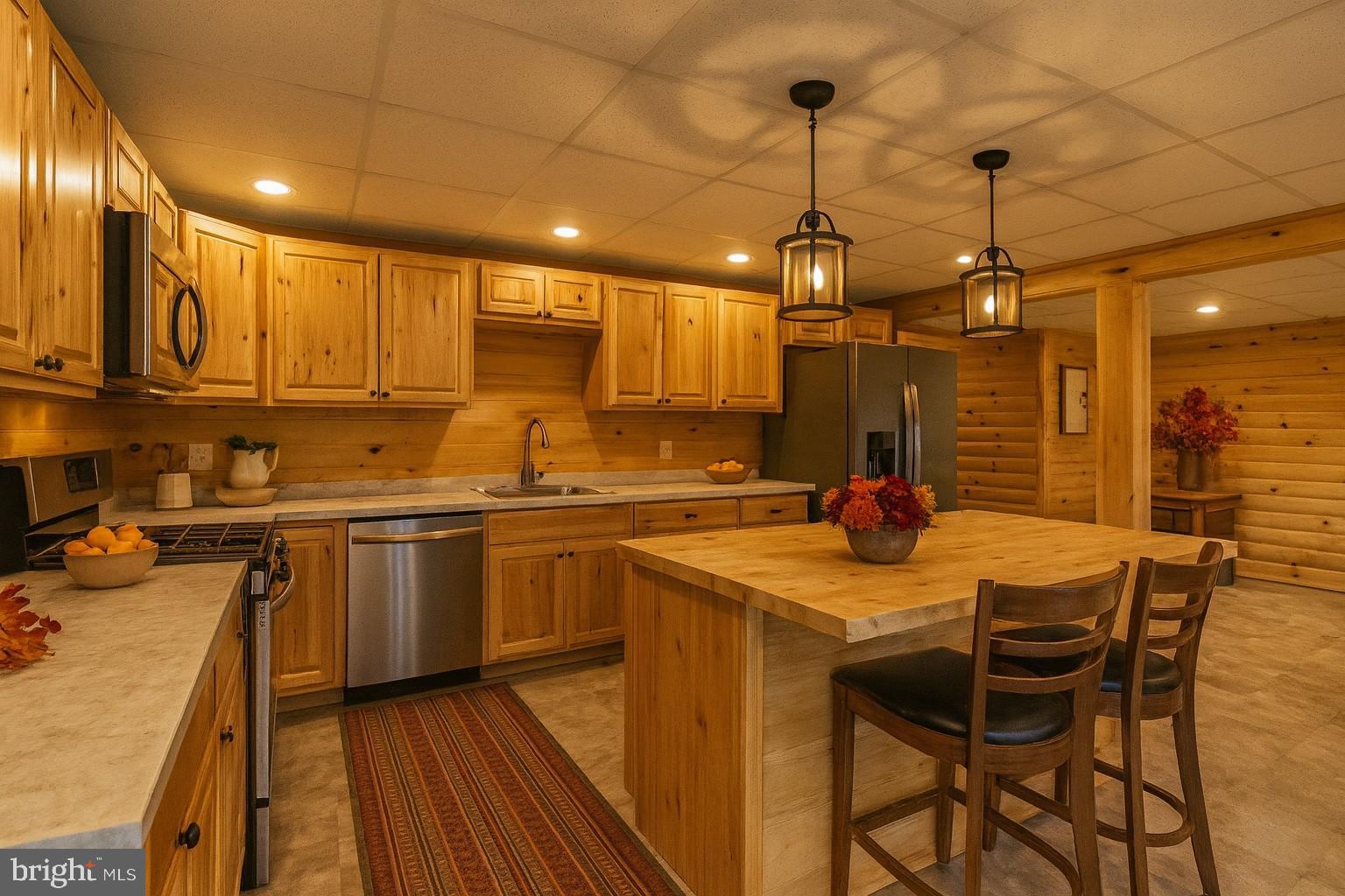107 Linkin Park Drive Spring Mills, PA 16875 - Photo 48 of 66 a kitchen with stainless steel appliances granite countertop a sink a stove and a wooden floors