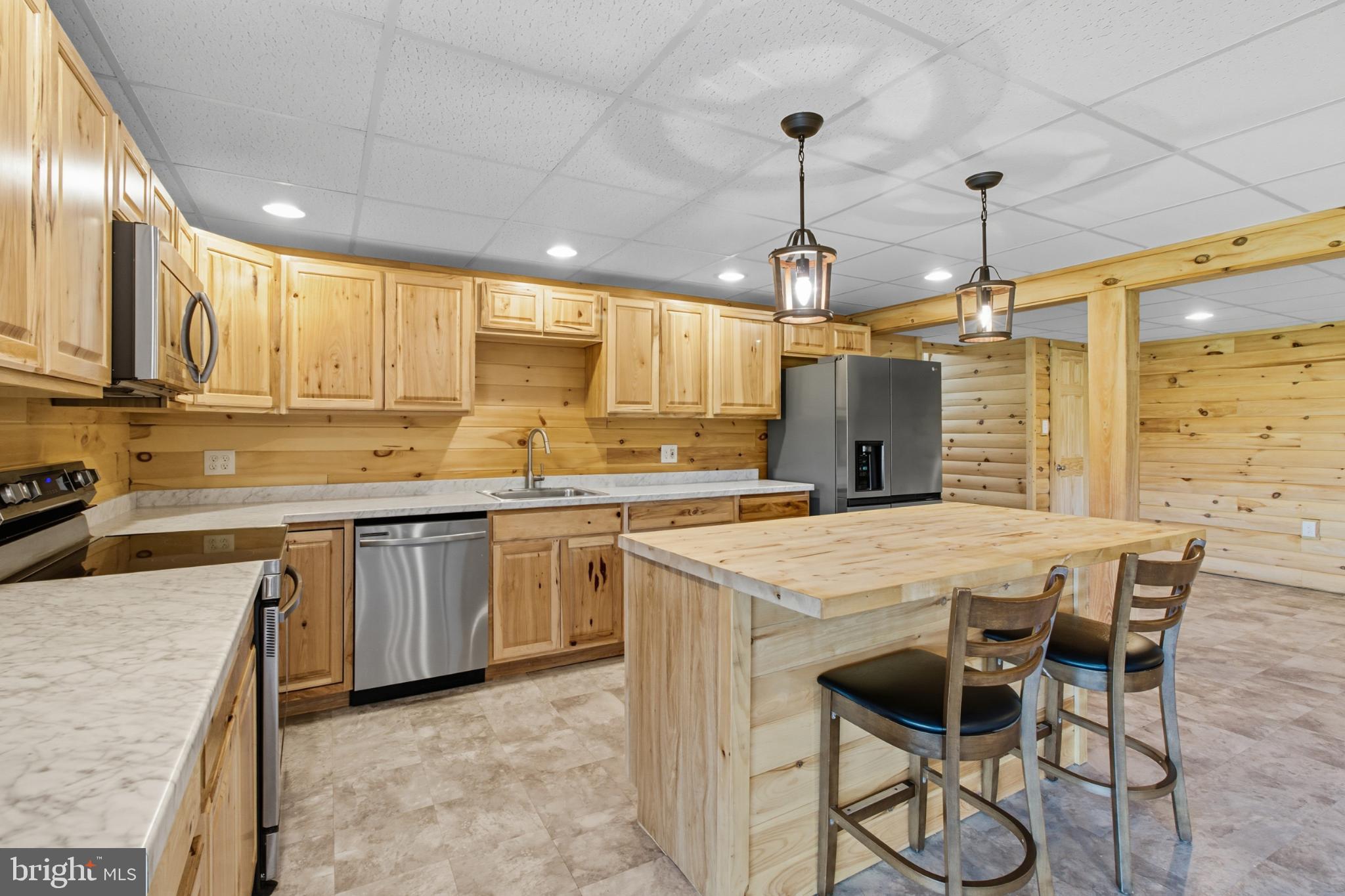 107 Linkin Park Drive Spring Mills, PA 16875 - Photo 49 of 66 a kitchen with stainless steel appliances granite countertop a stove top oven a refrigerator a sink and white cabinets