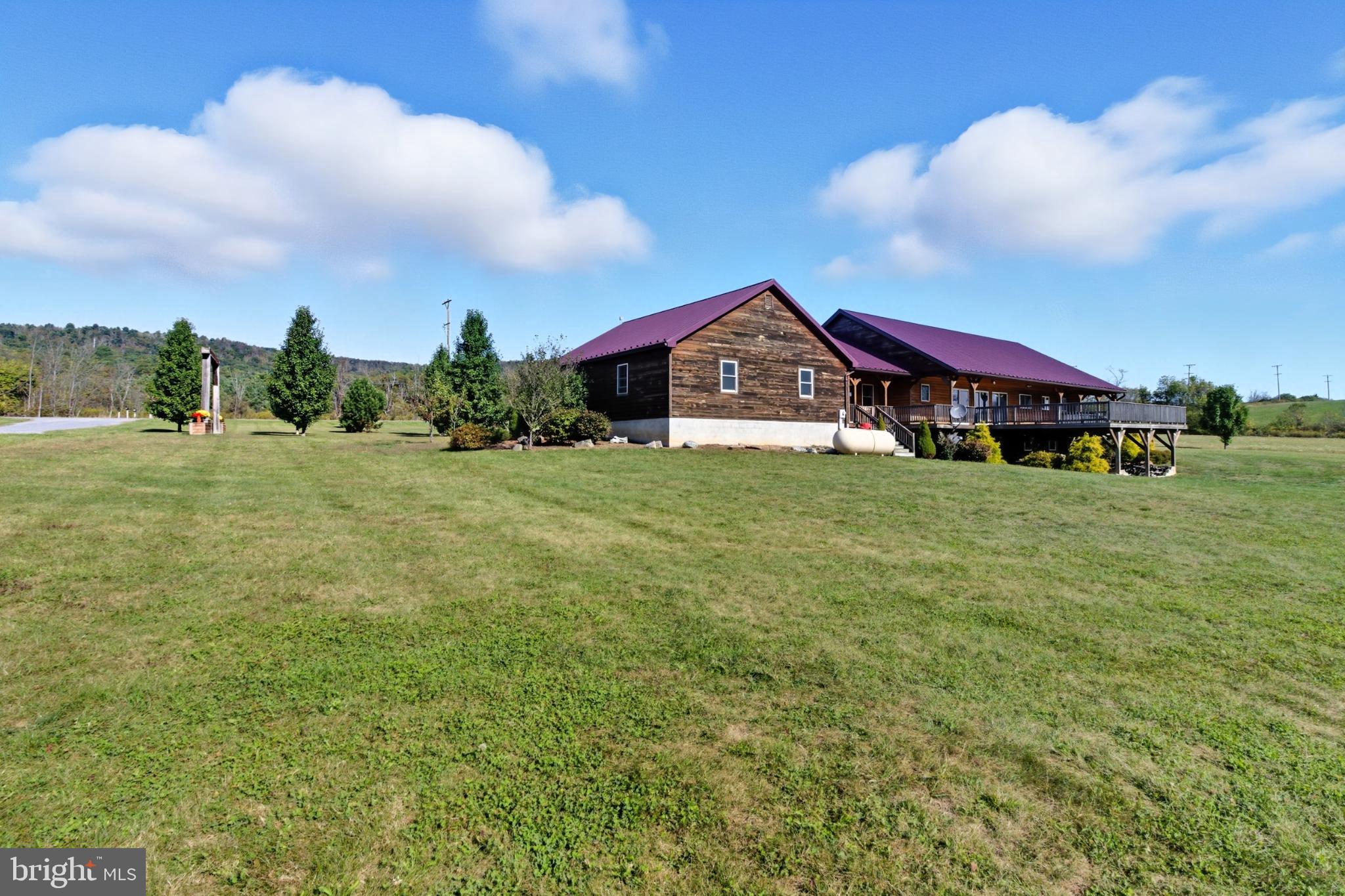 107 Linkin Park Drive Spring Mills, PA 16875 - Photo 65 of 66 a view of a big house with a big yard and large trees