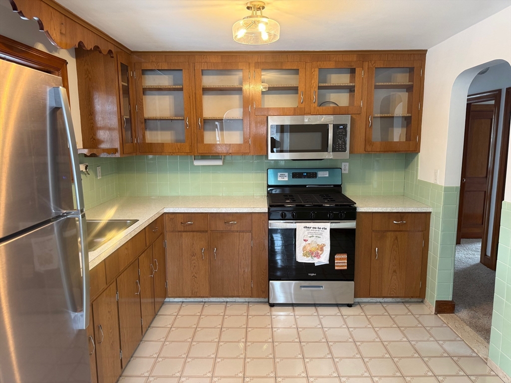 970 Trapelo Road Waltham, MA 02452 - Photo 1 of 25 a kitchen with granite countertop a refrigerator a stove and a sink