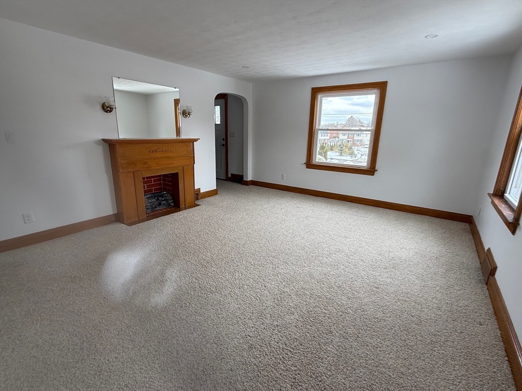 970 Trapelo Road Waltham, MA 02452 - Photo 11 of 25 an empty room with windows fireplace and windows
