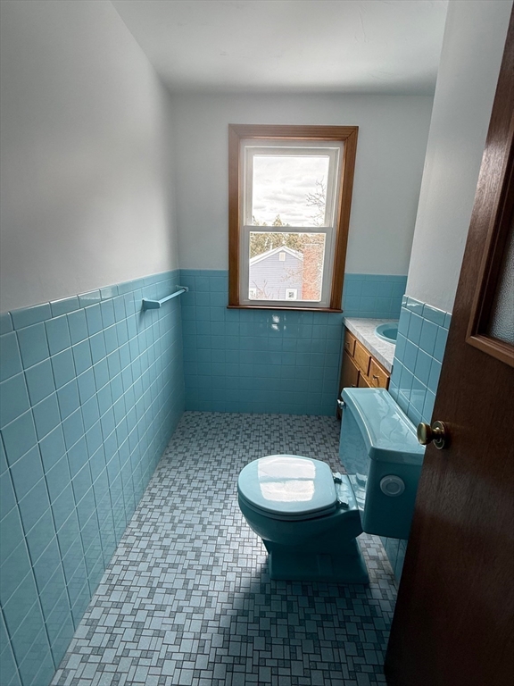 970 Trapelo Road Waltham, MA 02452 - Photo 15 of 25 a bathroom with a sink toilet and window