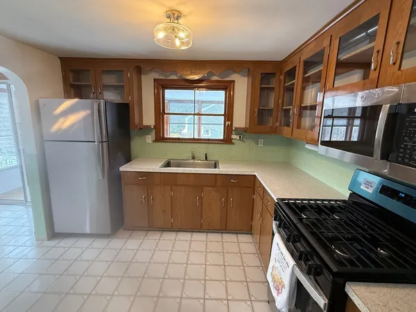 a kitchen with granite countertop a refrigerator and a sink