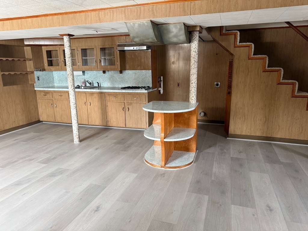 970 Trapelo Road Waltham, MA 02452 - Photo 22 of 25 a room with wooden floor and more cabinets