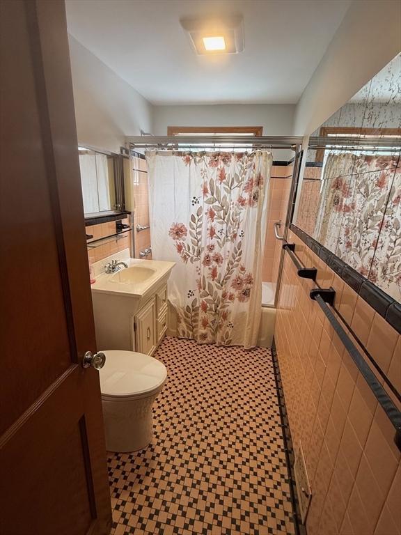 970 Trapelo Road Waltham, MA 02452 - Photo 4 of 25 a bathroom with a sink a toilet a mirror and shower