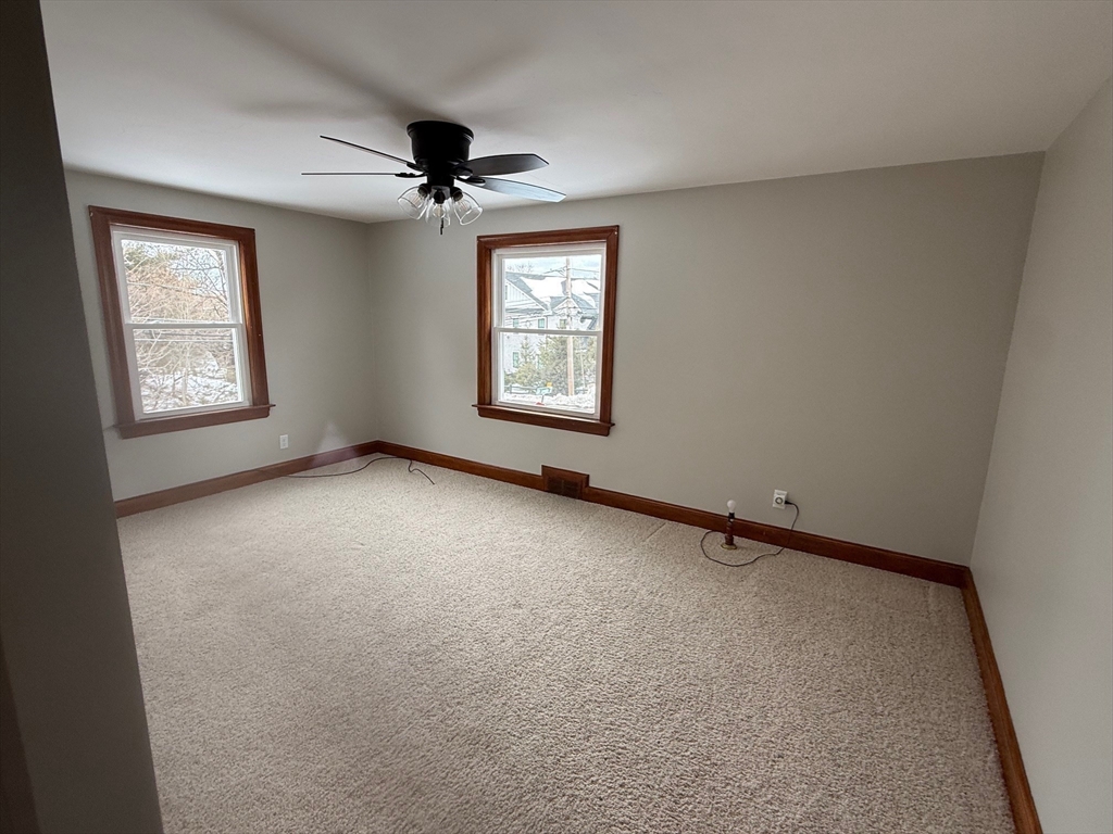 970 Trapelo Road Waltham, MA 02452 - Photo 7 of 25 an empty room with a window and a ceiling fan