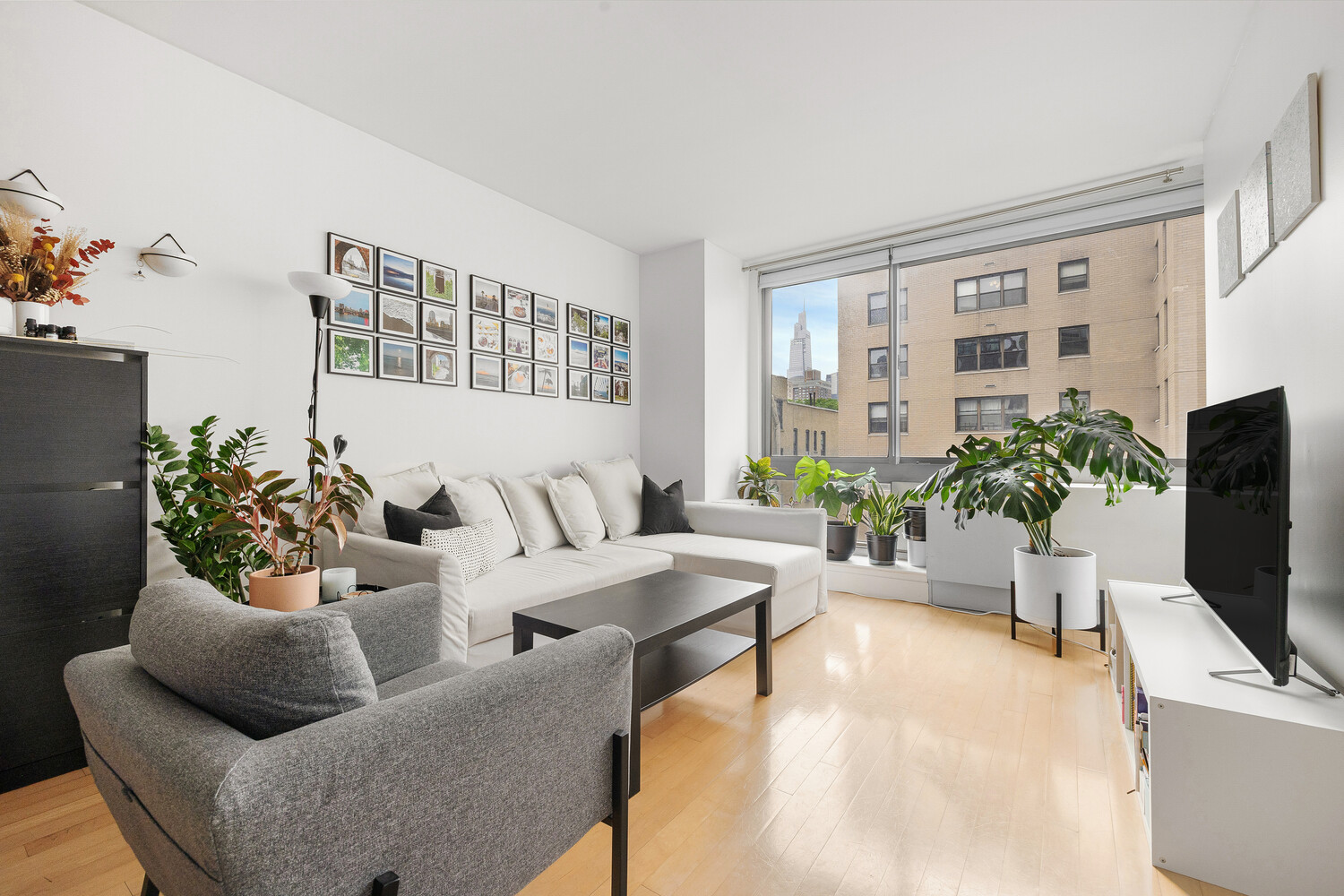 242 East 25th Street, Unit 7C Manhattan, NY 10010 - Photo 2 of 10 a living room with furniture and a flat screen tv