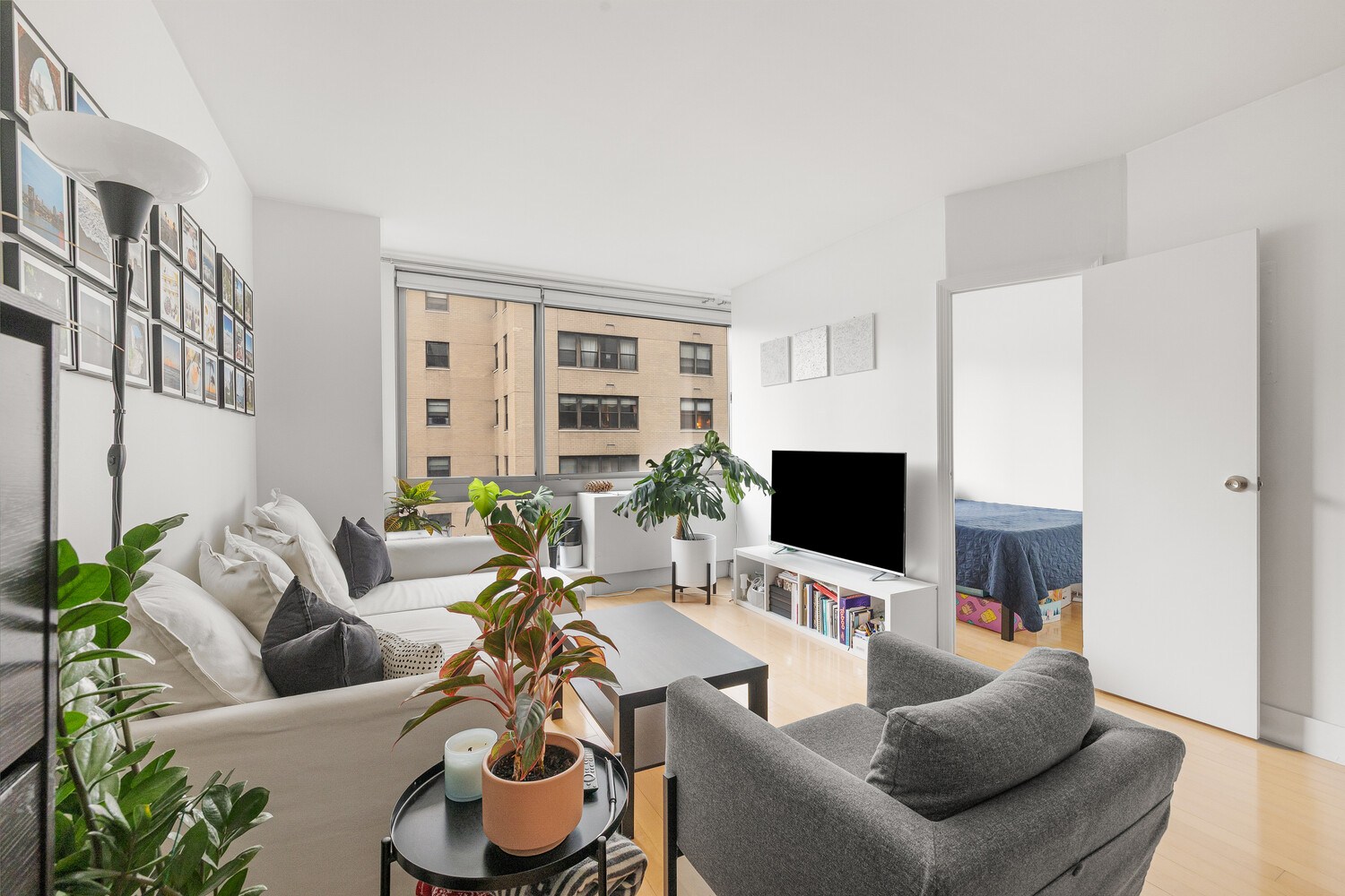 242 East 25th Street, Unit 7C Manhattan, NY 10010 - Photo 3 of 10 a living room with furniture and a flat screen tv