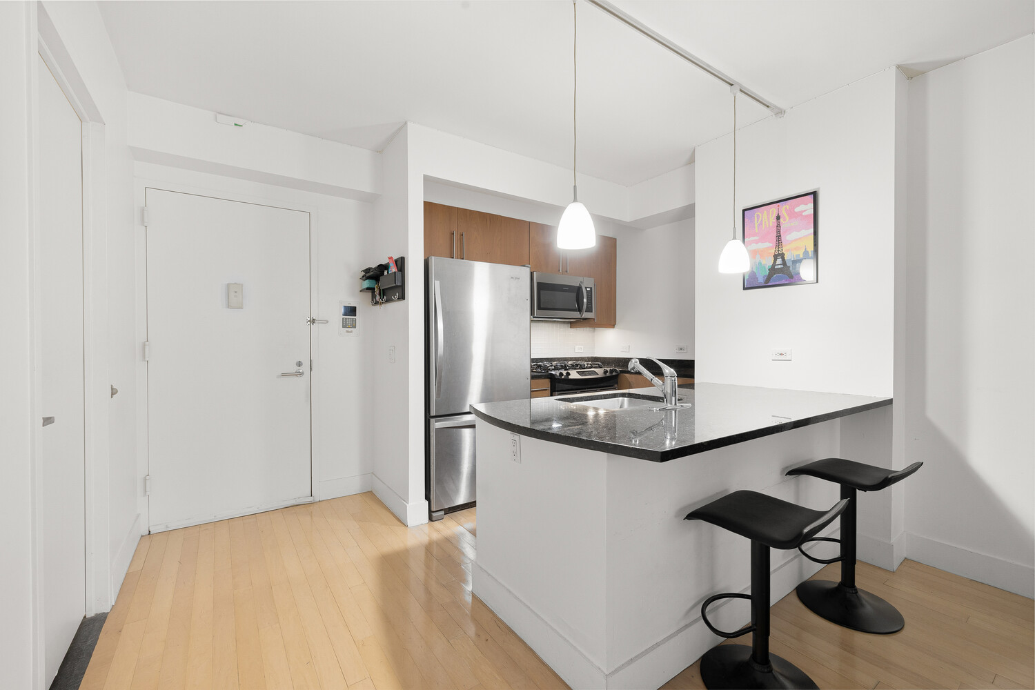 242 East 25th Street, Unit 7C Manhattan, NY 10010 - Photo 4 of 10 a kitchen with stainless steel appliances a stove a refrigerator and cabinets