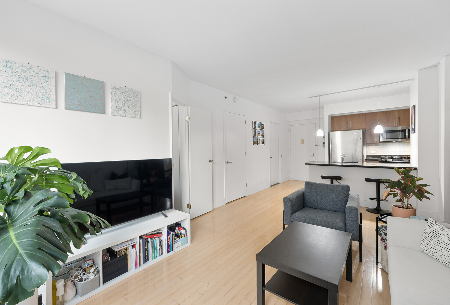242 East 25th Street, Unit 7C Manhattan, NY 10010 - Photo 6 of 10 a living room with furniture and a flat screen tv
