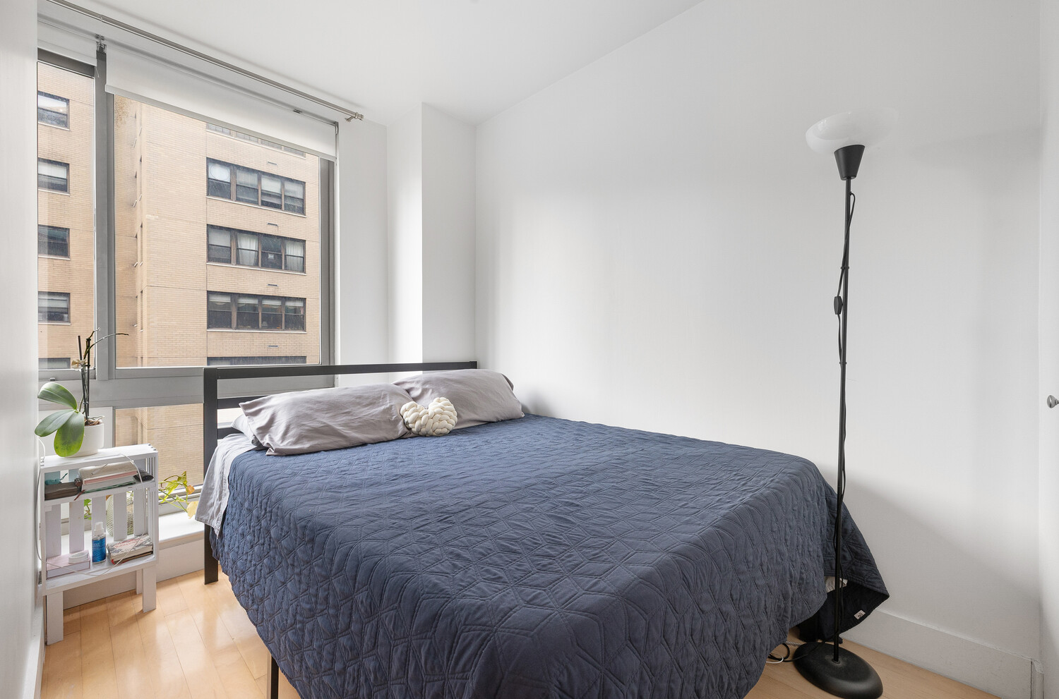 242 East 25th Street, Unit 7C Manhattan, NY 10010 - Photo 7 of 10 a bedroom with a bed window and a table