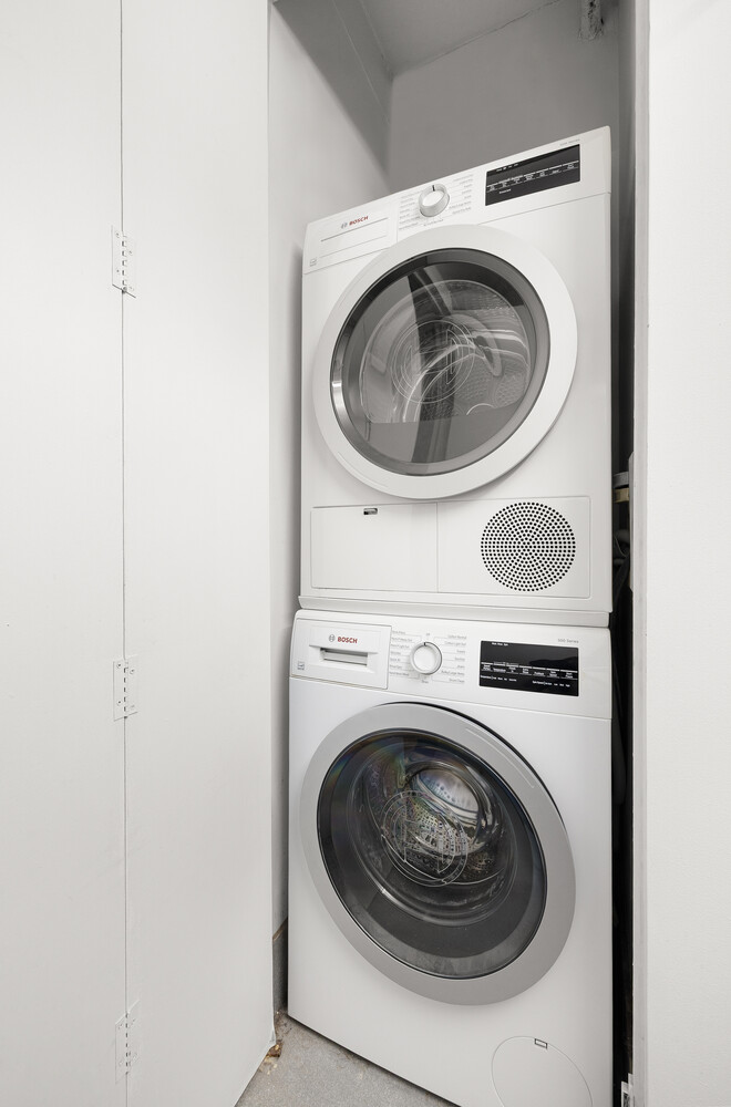 242 East 25th Street, Unit 7C Manhattan, NY 10010 - Photo 9 of 10 a utility room with dryer and washer