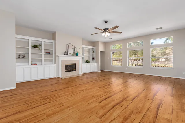 a bathroom with a granite countertop sink a toilet and a large mirror