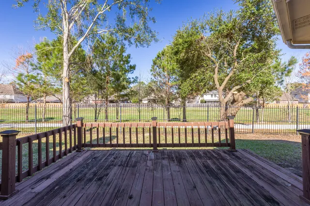 a view of a room with wooden floor and kitchen view
