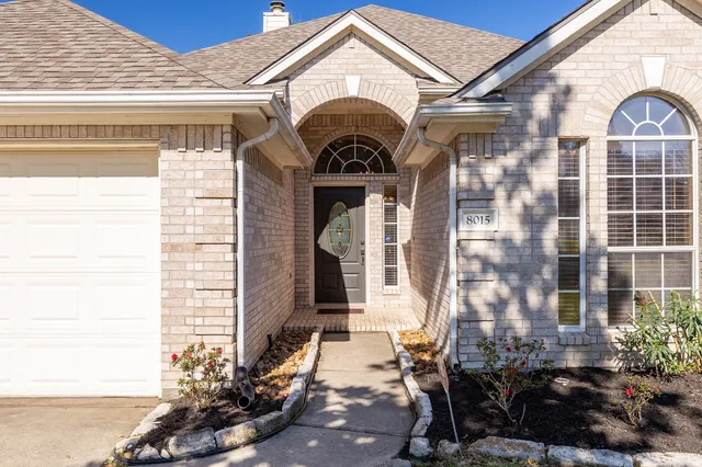 a kitchen with stainless steel appliances a sink window and cabinets