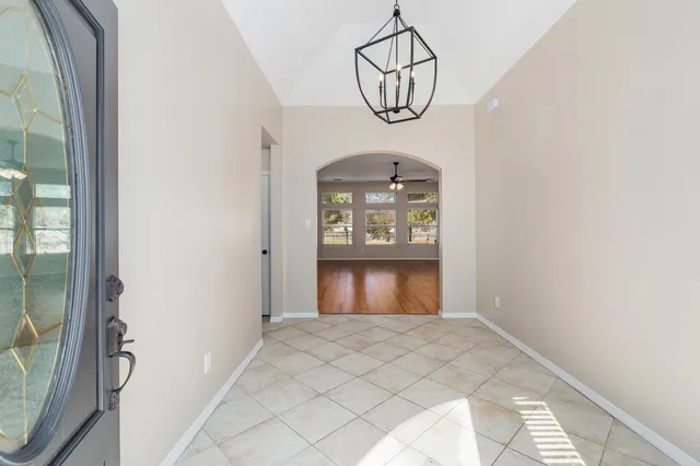 a bathroom with a tub shower and mirror