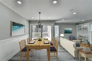 a view of a dining room with furniture wooden floor and chandelier