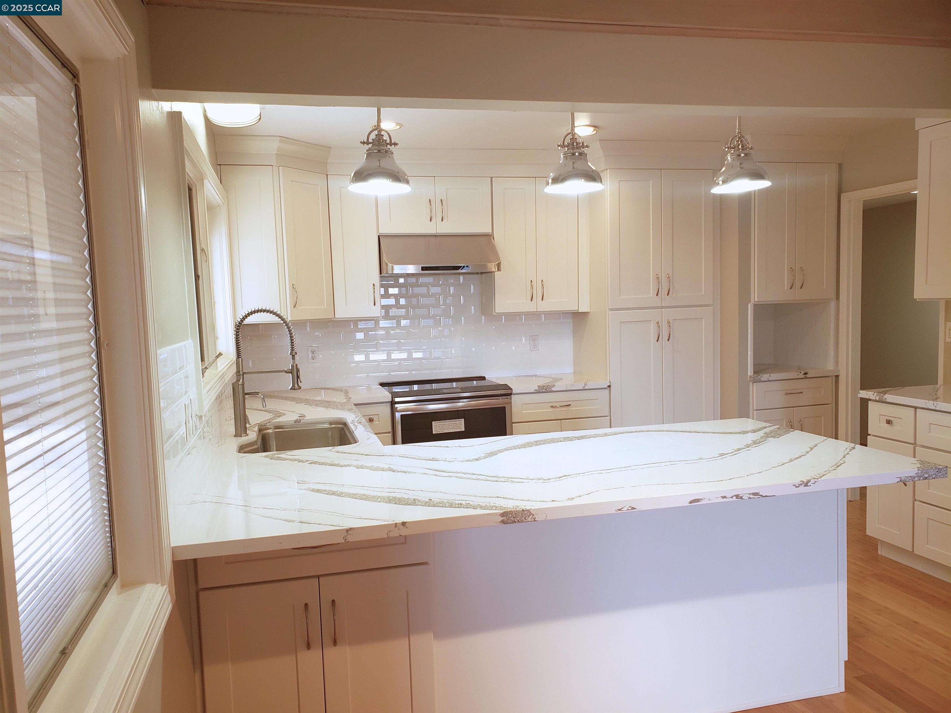 29 Chapel Drive Lafayette, CA 94549 - Photo 2 of 22 a kitchen with kitchen island a sink stainless steel appliances and cabinets