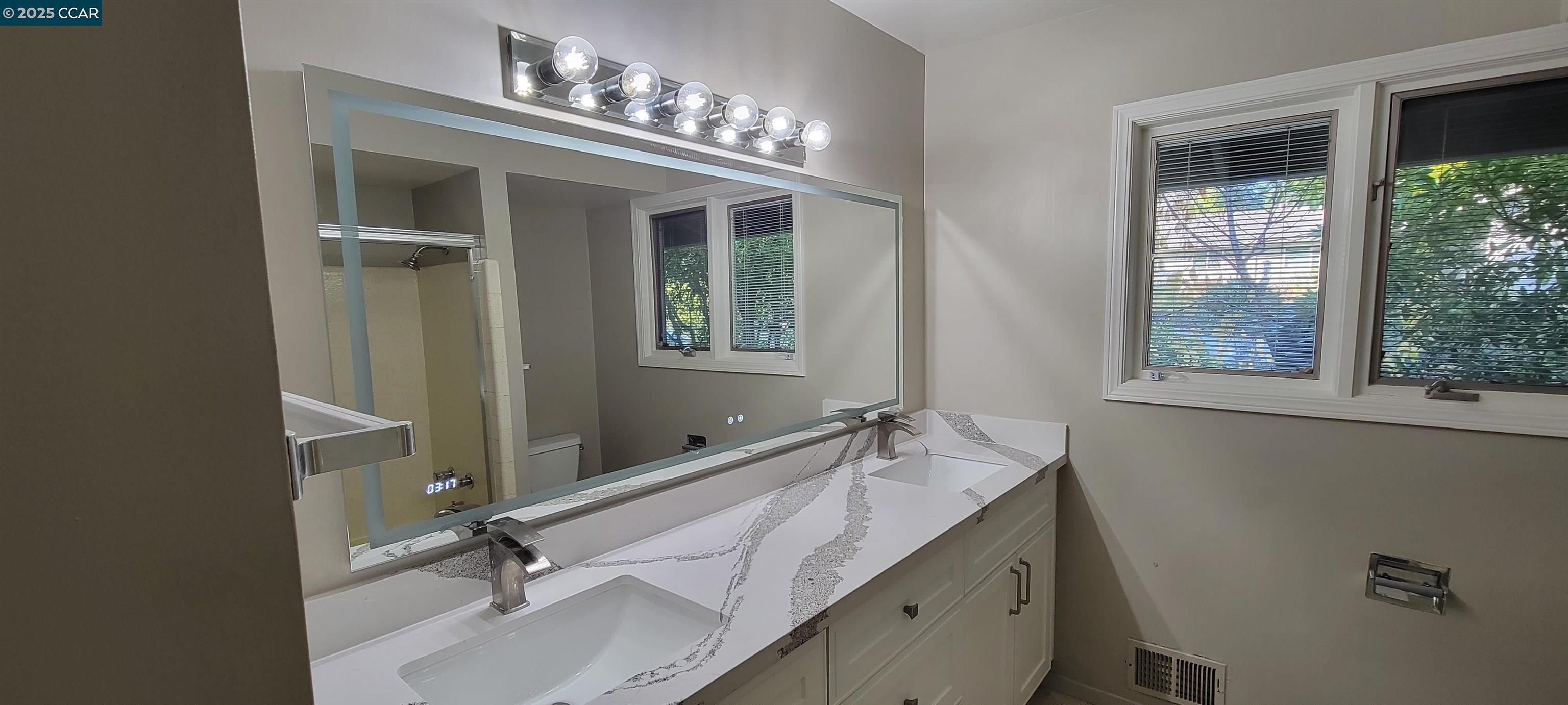 29 Chapel Drive Lafayette, CA 94549 - Photo 10 of 22 a bathroom with a double vanity sink and a mirror