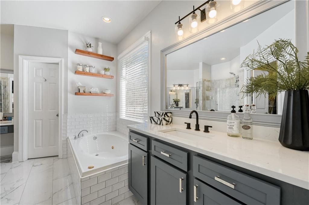 14124 Hopewell Road Alpharetta, GA 30004 - Photo 11 of 31 a bathroom with a double vanity sink mirror and bathtub