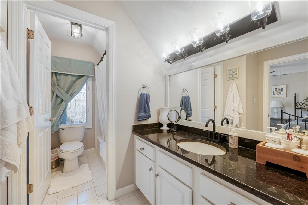 14124 Hopewell Road Alpharetta, GA 30004 - Photo 17 of 31 a bathroom with a granite countertop sink and a mirror