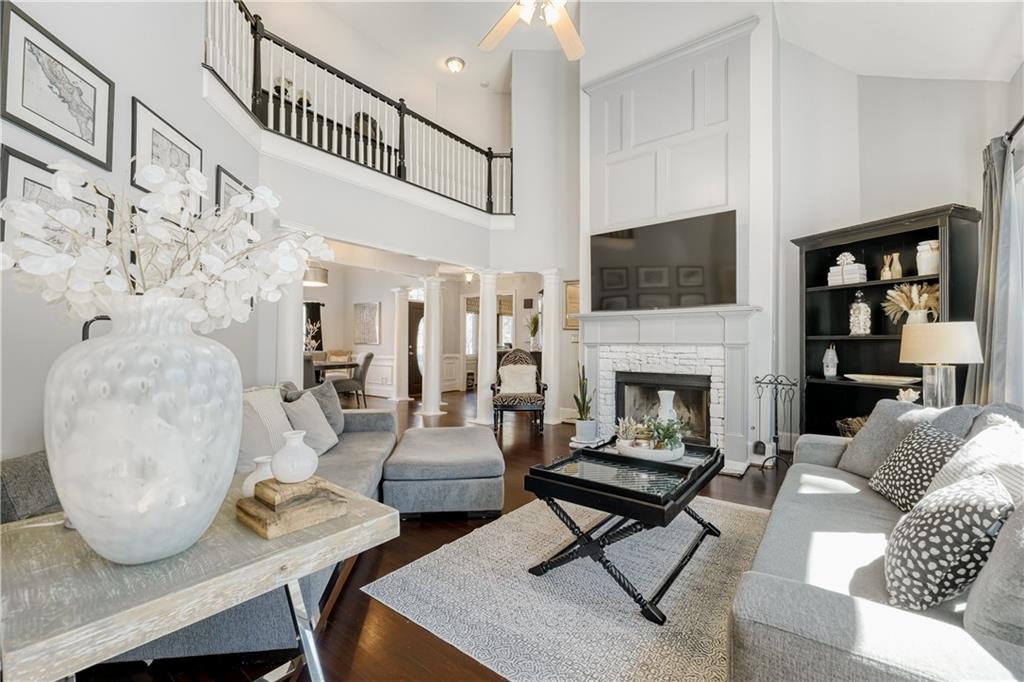 14124 Hopewell Road Alpharetta, GA 30004 - Photo 2 of 31 a living room with furniture a flat screen tv and a fireplace