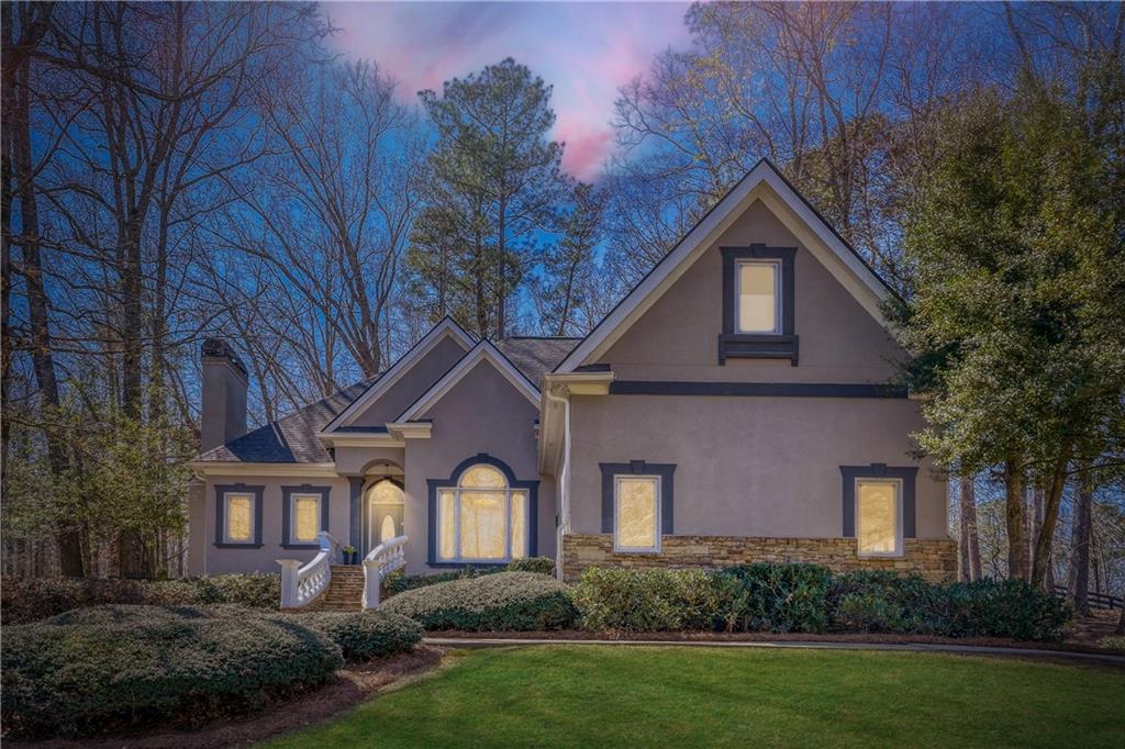 14124 Hopewell Road Alpharetta, GA 30004 - Photo 22 of 31 a front view of a house with a yard and garage