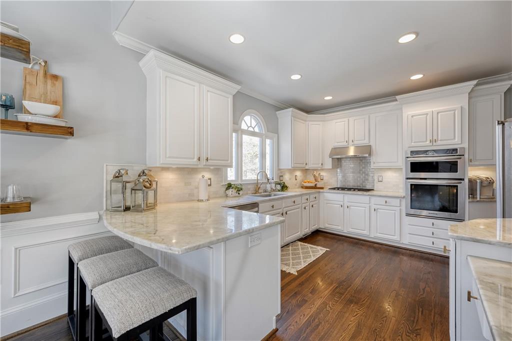 14124 Hopewell Road Alpharetta, GA 30004 - Photo 3 of 31 a kitchen with a center island appliances and cabinets