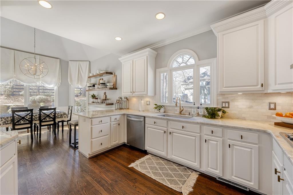 14124 Hopewell Road Alpharetta, GA 30004 - Photo 4 of 31 a kitchen with sink cabinets and wooden floor