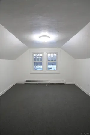 an empty room with a empty space and windows