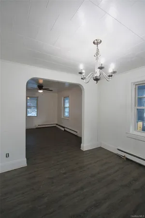 a view of a livingroom with wooden floor and a ceiling fan