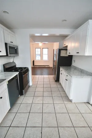 a kitchen with stainless steel appliances a sink a stove a microwave and cabinets