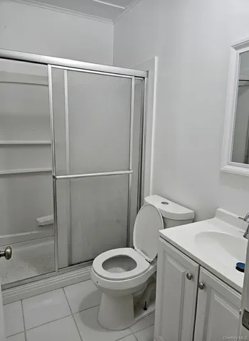 a white toilet sitting next to a shower
