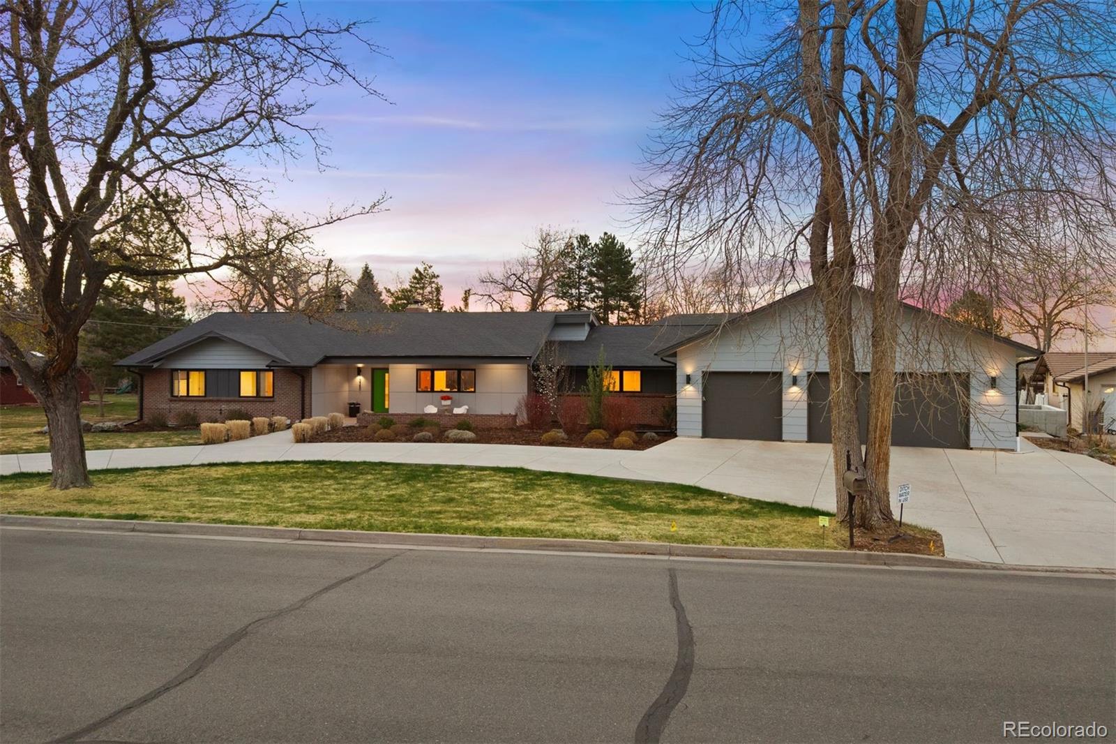 a view of a house with a yard covered in snow
