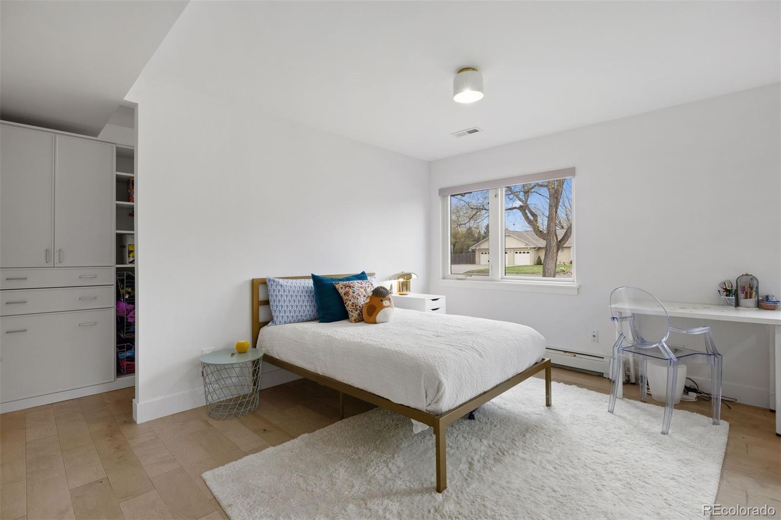 13380 Braun Road Golden, CO 80401 - Photo 27 of 49 a bedroom with a bed and wooden floor