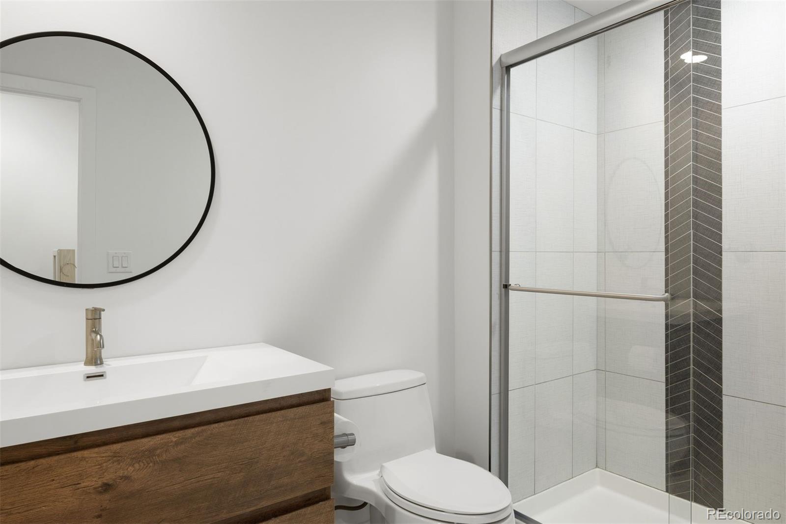 13380 Braun Road Golden, CO 80401 - Photo 29 of 49 a bathroom with a sink a toilet and a mirror