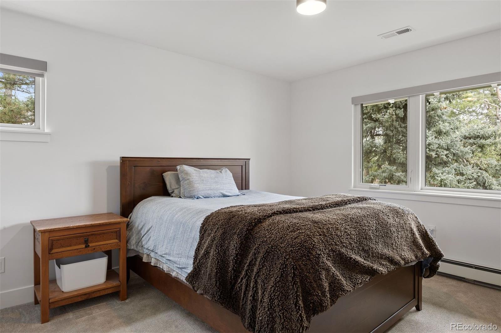 13380 Braun Road Golden, CO 80401 - Photo 31 of 49 a bed sitting in a bedroom next to a window