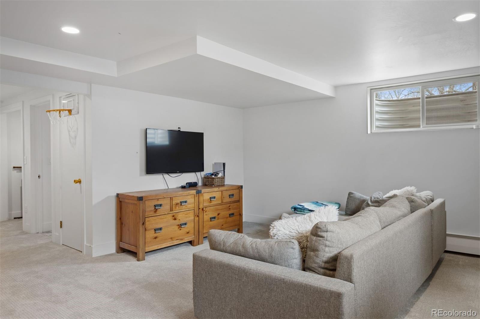 13380 Braun Road Golden, CO 80401 - Photo 32 of 49 a living room with furniture and a flat screen tv