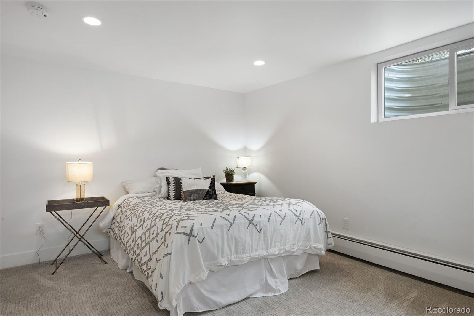 13380 Braun Road Golden, CO 80401 - Photo 33 of 49 a bedroom with a bed and lamp